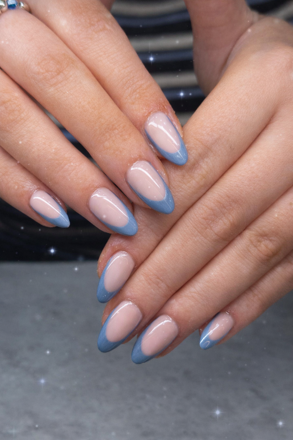 Glossy almond French manicure with dusty blue tips