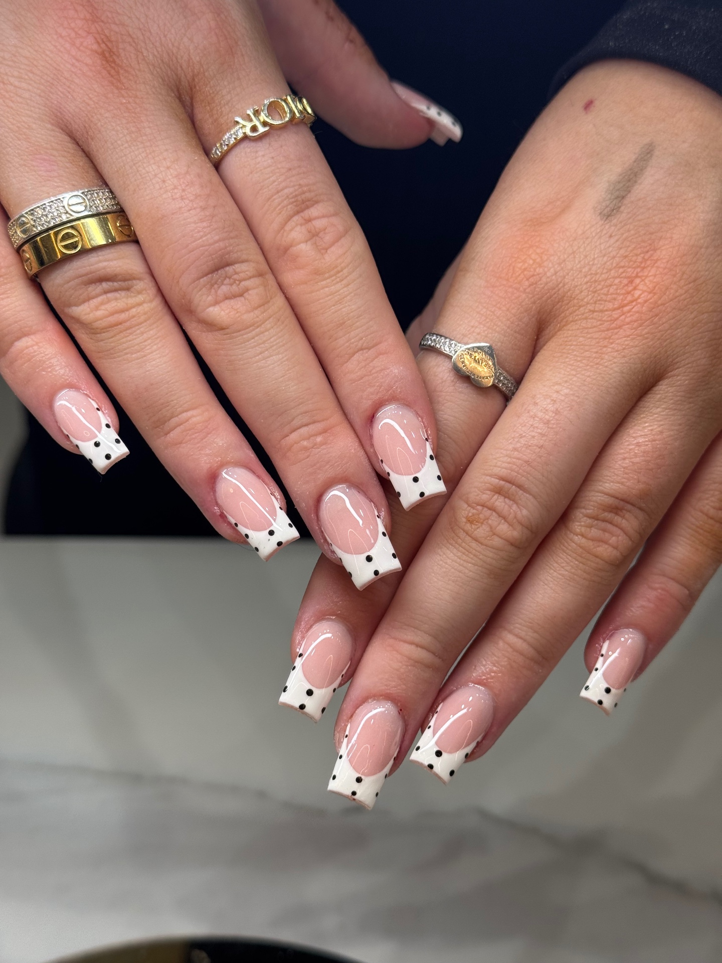 Long square white French tips with delicate black polka dots
