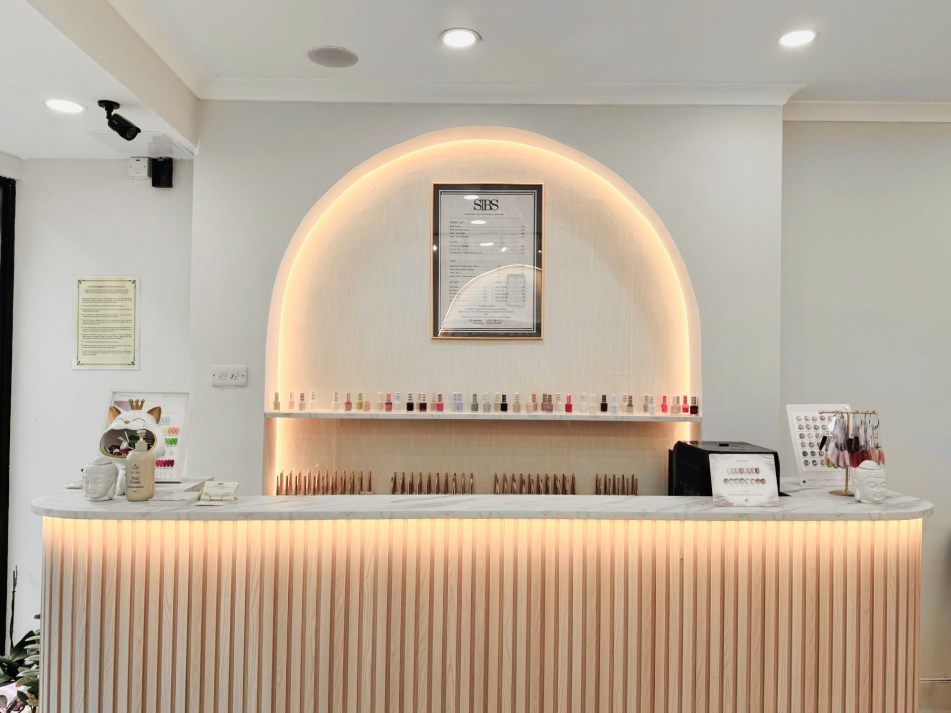 Fluted reception desk with backlit arch
