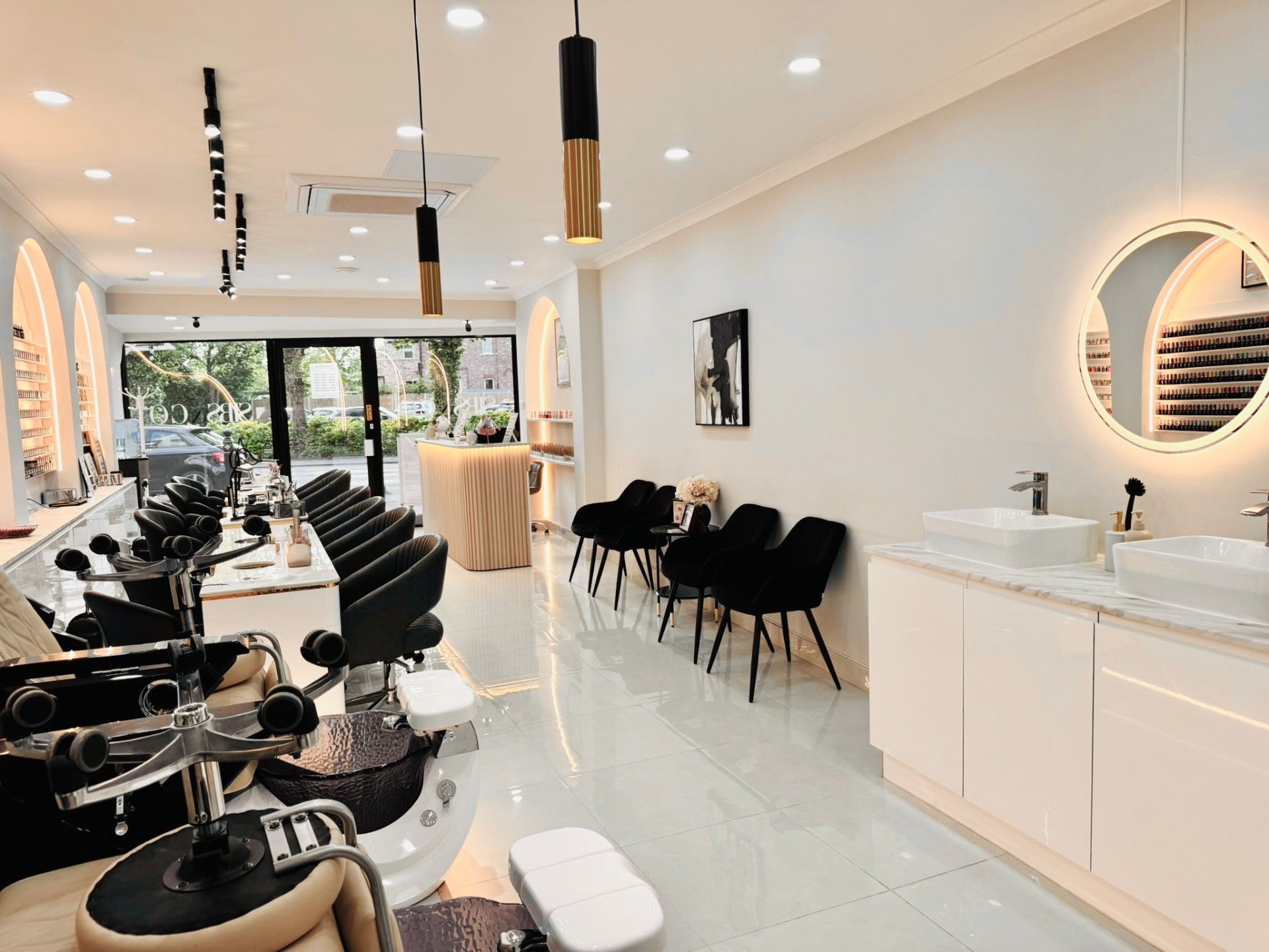 Inside Sibs Nails, with elegant manicure stations and a wall of colour